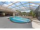 Relaxing view of outdoor pool with lounge chairs and a clear blue sky, enclosed in screened frame at 1825 Myrtle Lake Ave, Fruitland Park, FL 34731