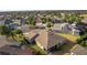 Aerial view of home featuring landscaped yard and screened-in lanai in a residential area at 2017 Royal Elm Rd, The Villages, FL 32162