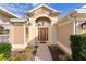 Inviting front entryway with a custom wood door, decorative glass, and covered porch at 2017 Royal Elm Rd, The Villages, FL 32162