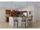 Kitchen featuring stainless steel appliances, breakfast bar, and wood cabinetry at 2017 Royal Elm Rd, The Villages, FL 32162