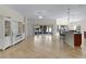 Open-concept living room featuring tile flooring, neutral walls, and sliding glass doors to the lanai at 2017 Royal Elm Rd, The Villages, FL 32162