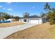 Newly built home with white exterior, gray roof, and a two-car garage at 202 Shannon Ln, Lady Lake, FL 32159