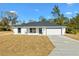 Newly constructed home with white exterior, gray roof, and two-car garage at 202 Shannon Ln, Lady Lake, FL 32159