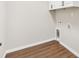 Laundry room with built-in cabinets and vinyl flooring at 202 Shannon Ln, Lady Lake, FL 32159