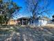 House exterior showcasing screened porch and yard at 2156 Cr 437A, Lake Panasoffkee, FL 33538