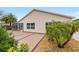 Landscaped backyard with covered patio and palm trees at 2222 Southwood Dr, The Villages, FL 32162