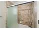 Bathroom with tub and sliding glass door at 2222 Southwood Dr, The Villages, FL 32162