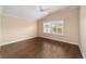 Bright bedroom with hardwood floors and large window with shutters at 2222 Southwood Dr, The Villages, FL 32162