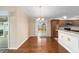 Hardwood floor dining room with chandelier and view to backyard at 2222 Southwood Dr, The Villages, FL 32162