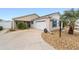 House exterior showcasing a two-car garage and well maintained landscaping at 2222 Southwood Dr, The Villages, FL 32162