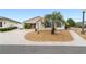 Single-story house with light beige siding, blue shutters, and a landscaped yard at 2222 Southwood Dr, The Villages, FL 32162