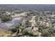 Beautiful aerial view of houses by lake and treed landscape at 225 Sutherland Ct, Apopka, FL 32712