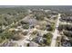 An aerial view of a neighborhood and green areas with ponds and a road at 225 Sutherland Ct, Apopka, FL 32712