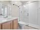 A bathroom features a shower with glass door, wooden cabinets, and a single sink at 225 Sutherland Ct, Apopka, FL 32712