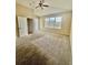 Spacious carpeted bedroom with large window and ceiling fan at 225 Sutherland Ct, Apopka, FL 32712