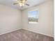 Bright bedroom with a neutral carpet, a window, and a ceiling fan at 225 Sutherland Ct, Apopka, FL 32712