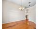 Spacious dining room featuring wood floors, a chandelier, and neutral wall paint at 225 Sutherland Ct, Apopka, FL 32712