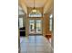 Bright entryway with double doors and tile floors at 225 Sutherland Ct, Apopka, FL 32712