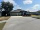 Three-car garage and large driveway at 225 Sutherland Ct, Apopka, FL 32712