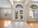 Welcoming foyer with tile flooring, double doors, and abundant natural light from large windows at 225 Sutherland Ct, Apopka, FL 32712