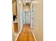 Light-filled hallway with wood flooring and access to bedrooms at 225 Sutherland Ct, Apopka, FL 32712