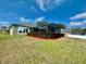 Back exterior view of house, showcasing landscaping at 225 Sutherland Ct, Apopka, FL 32712