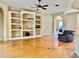 Living room featuring hardwood floors and built-in shelving at 225 Sutherland Ct, Apopka, FL 32712