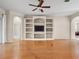 Inviting living room featuring wood floors, built-in shelving, and a ceiling fan at 225 Sutherland Ct, Apopka, FL 32712