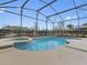 Screened in pool with adjacent hot tub and a well manicured landscape at 225 Sutherland Ct, Apopka, FL 32712