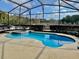 Inviting screened pool and spa with tranquil views at 225 Sutherland Ct, Apopka, FL 32712