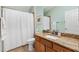 Bathroom featuring wood vanity with granite countertop, tile floors, and shower/bath combo at 2303 Nehaul Ter, The Villages, FL 32162