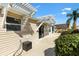 This exterior shows a covered patio with landscaping, adding a touch of nature to the outdoor space at 2303 Nehaul Ter, The Villages, FL 32162