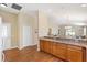 Kitchen featuring granite countertops, ample cabinet space, and wood floors at 2303 Nehaul Ter, The Villages, FL 32162