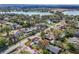 Aerial view of a single story home with lake views, featuring a well-maintained lawn and carport at 2384 Orange Capital Ct, Eustis, FL 32726