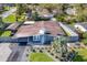 Aerial view of a single story home featuring a well-maintained lawn, carport, and elegant landscaping at 2384 Orange Capital Ct, Eustis, FL 32726