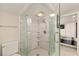 Updated bathroom featuring a glass enclosed shower with decorative tile and modern fixtures at 2384 Orange Capital Ct, Eustis, FL 32726