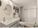 Clean and modern bathroom offers comfort and style, enhanced by an oval mirror above the sleek vanity sink at 2384 Orange Capital Ct, Eustis, FL 32726