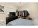 Neutral bedroom with an open wardrobe, television on a dresser and natural light at 2384 Orange Capital Ct, Eustis, FL 32726