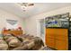 Bedroom with a large television, dresser, and an ensuite bathroom with a tiled shower at 2384 Orange Capital Ct, Eustis, FL 32726