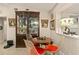 Cozy dining area featuring a round table, clear chairs with orange cushions, and a glass display cabinet at 2384 Orange Capital Ct, Eustis, FL 32726