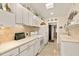 Cozy kitchen with white cabinets, tile backsplash, and modern appliances at 2384 Orange Capital Ct, Eustis, FL 32726