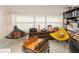 Living room featuring chess table, unique chairs, and shelving with vintage decor at 2384 Orange Capital Ct, Eustis, FL 32726