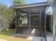 Enclosed screen porch with ceiling fan offering bug-free outdoor relaxation at 2384 Orange Capital Ct, Eustis, FL 32726