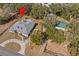 Aerial view of a home with a pool, long driveway, and large surrounding lot at 24429 Adair Ave, Sorrento, FL 32776