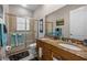 Bathroom with double vanity featuring granite countertops and glass-enclosed shower at 24429 Adair Ave, Sorrento, FL 32776