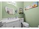 Stylish bathroom with vanity, round mirror, and decorative accents at 24429 Adair Ave, Sorrento, FL 32776