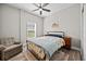 Bright bedroom with wood-look flooring, ceiling fan, and natural light at 24429 Adair Ave, Sorrento, FL 32776