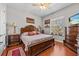 Spacious bedroom featuring hardwood floors, a ceiling fan, and a large window at 24429 Adair Ave, Sorrento, FL 32776