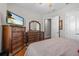 Bedroom featuring hardwood floors, furniture, neutral walls and white trim at 24429 Adair Ave, Sorrento, FL 32776