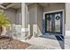 Front entry featuring double doors with decorative wreaths and stone-accented columns at 24429 Adair Ave, Sorrento, FL 32776